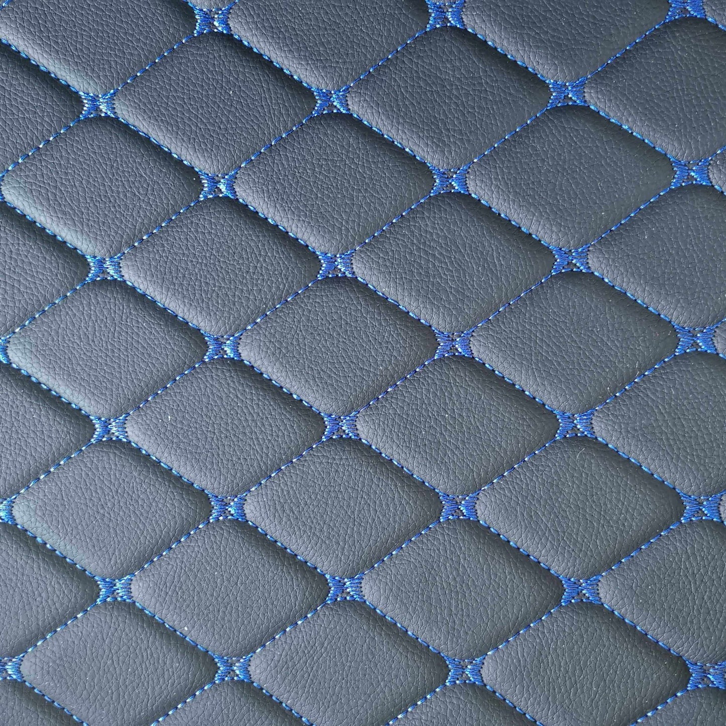 Close-up of diamond-stitched car mat texture in gray and blue, showcasing a stylish and durable design.