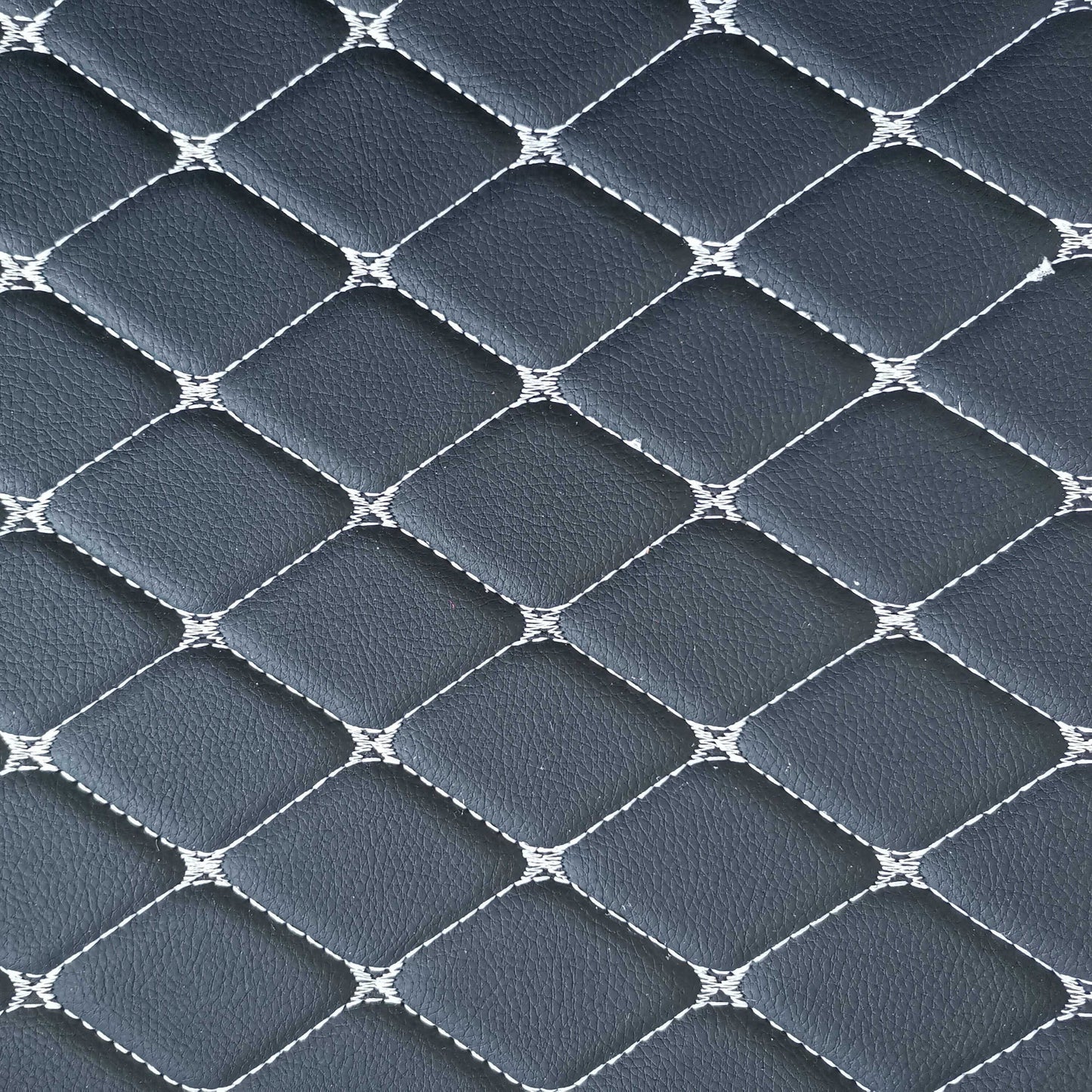 Close-up of Lux-Beautyplus™ diamond-stitched leather car mat design in dark gray for stylish interiors.