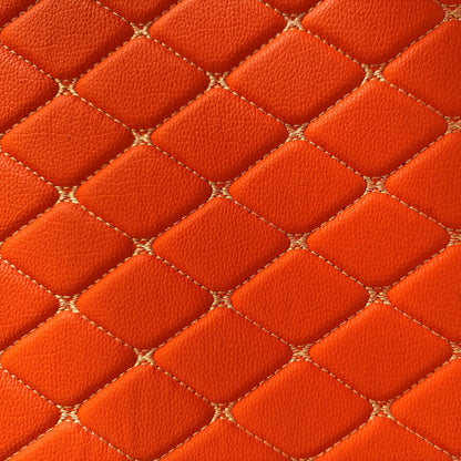 Close-up of diamond-stitched orange leather texture, showcasing a luxurious and modern design.