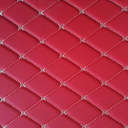 Close-up view of diamond-stitched red leather pattern for car mats or interior design.