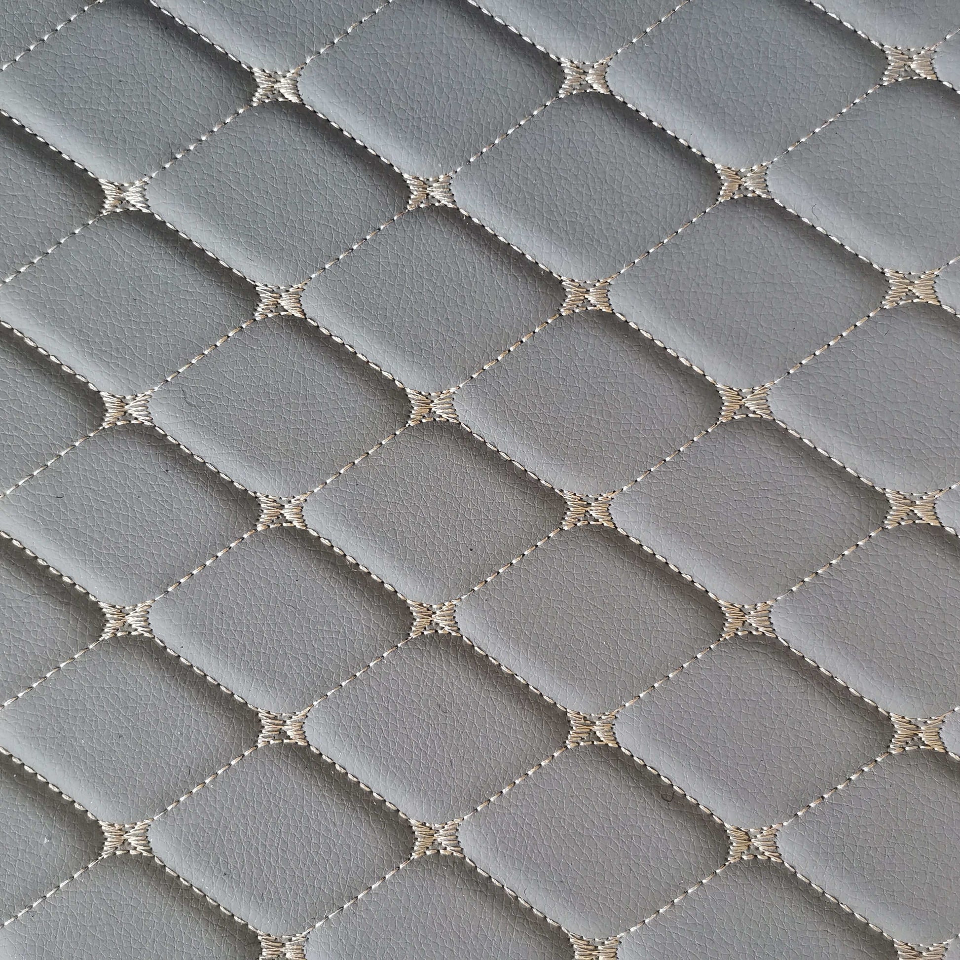 Close-up of diamond-stitched gray car mat surface, showcasing its durable and stylish design.