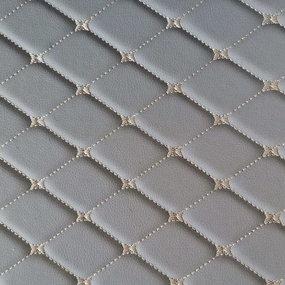 Close-up of diamond-stitched gray car mat surface, showcasing its durable and stylish design.